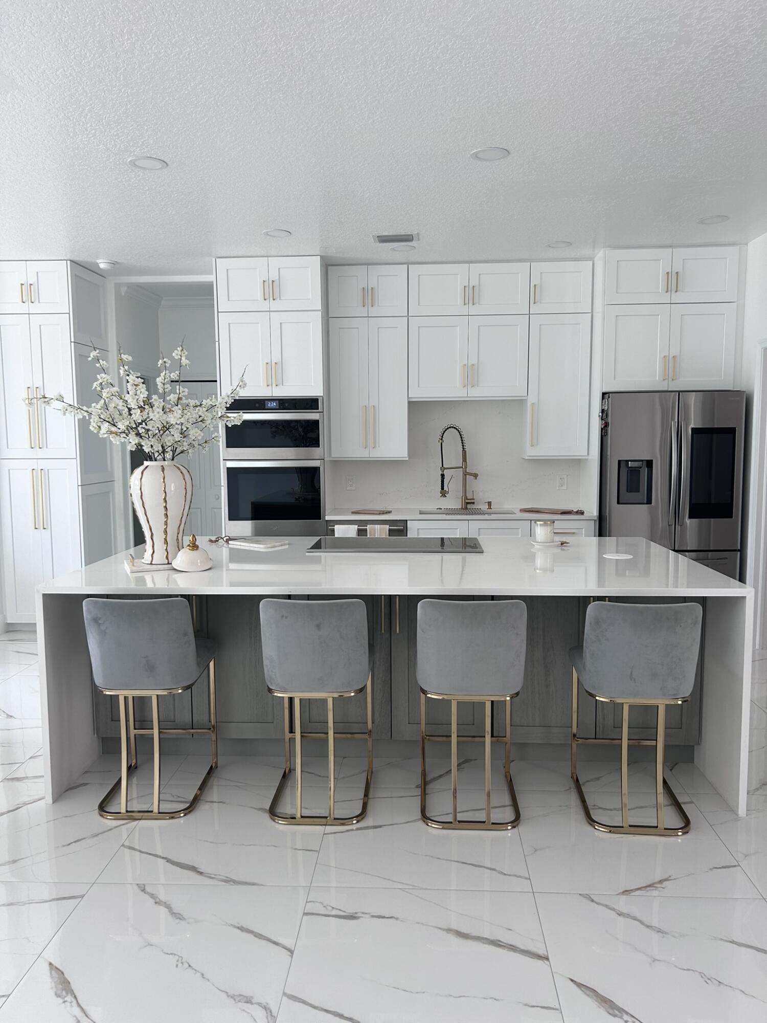 3158 Southwest Martin Street Port St. Lucie, FL 34953 - Photo 17 of 26 a kitchen with stainless steel appliances a dining table chairs microwave and sink