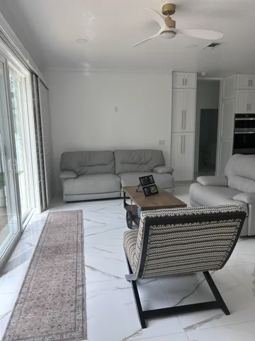 a view of a livingroom with furniture and a window
