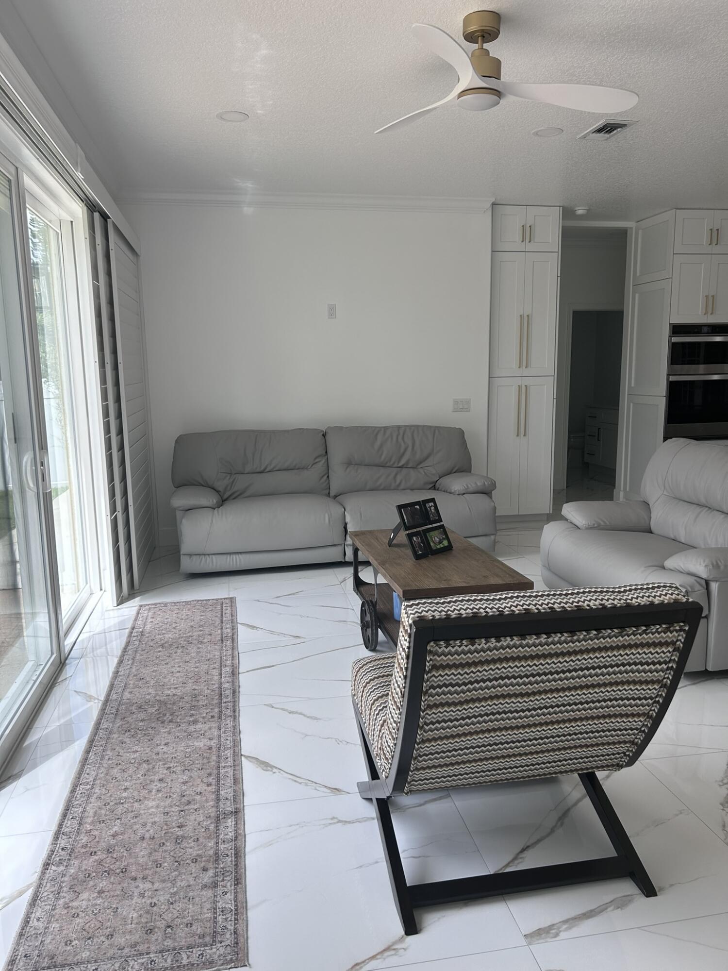 3158 Southwest Martin Street Port St. Lucie, FL 34953 - Photo 20 of 26 a living room with furniture and a rug