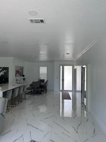 a view of a kitchen with cabinets and stainless steel appliances