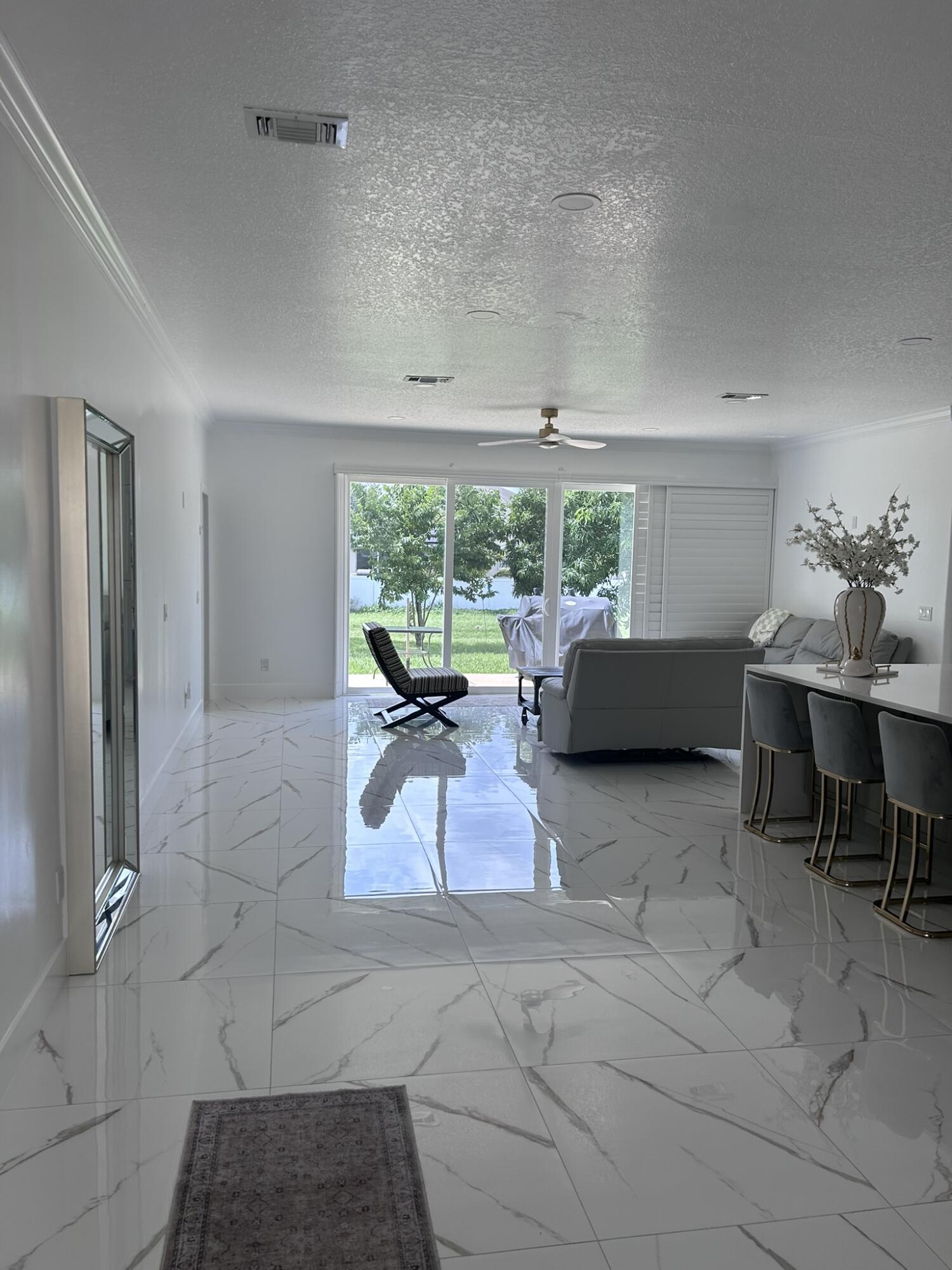 3158 Southwest Martin Street Port St. Lucie, FL 34953 - Photo 25 of 26 a living room with furniture and a large window