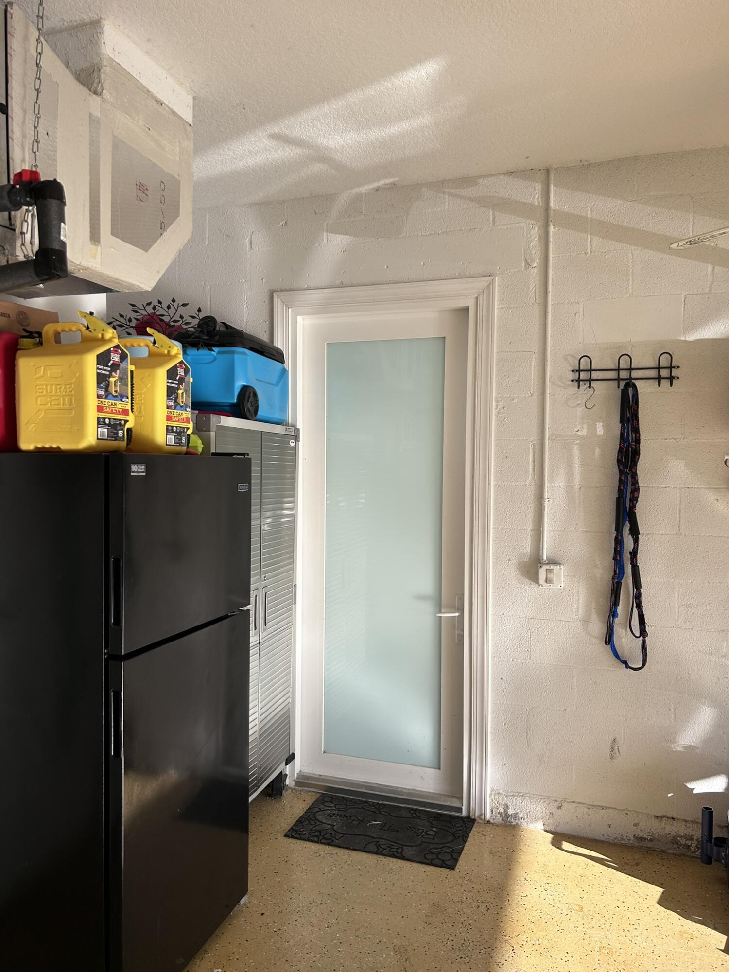 3158 Southwest Martin Street Port St. Lucie, FL 34953 - Photo 7 of 26 a kitchen with a refrigerator and countertop