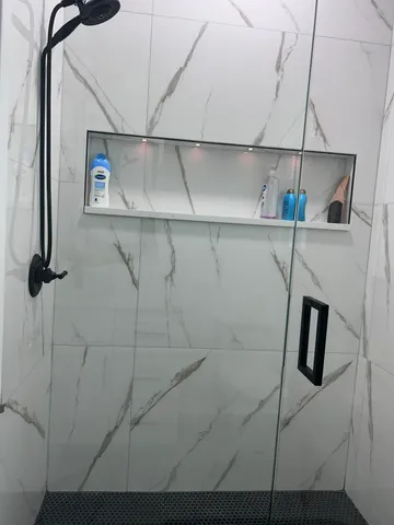 a bathroom with a toilet sink vanity and window