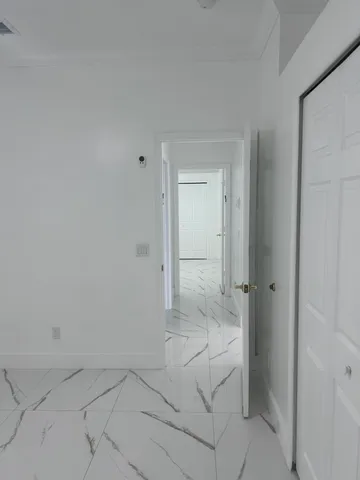 an empty room with a ceiling fan and window