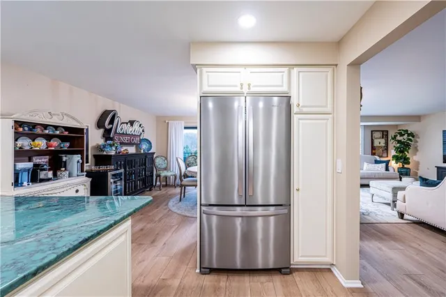 a kitchen with stainless steel appliances granite countertop a refrigerator and a sink