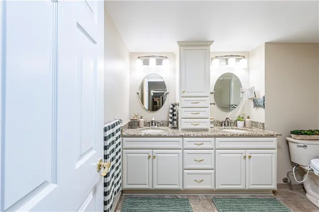 a spacious bathroom with a double vanity sink and a mirror