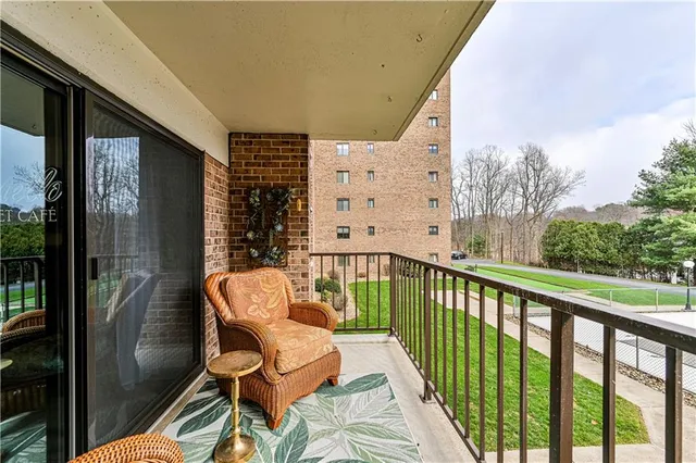 a balcony with table and chairs