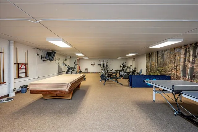 a living room with furniture chandelier and a large mirror