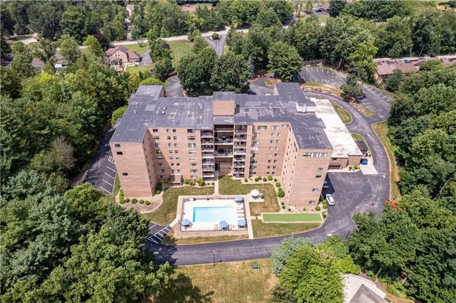 an aerial view of multiple houses with yard