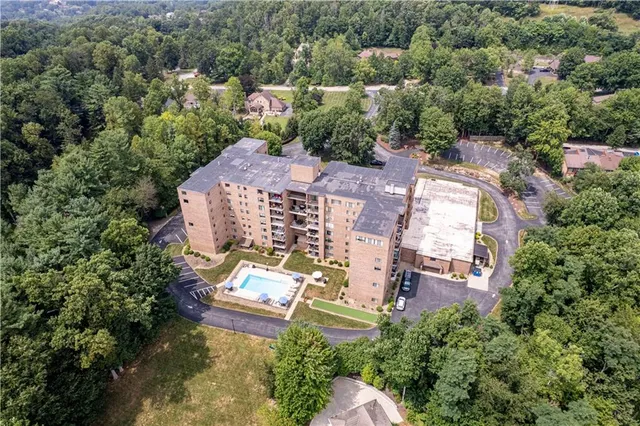 an aerial view of a house with yard swimming pool and outdoor seating