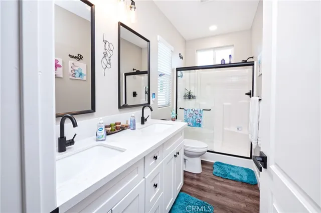 a white toilet sitting next to a bathroom sink