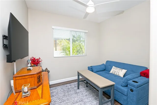 a living room with furniture and a wooden floor