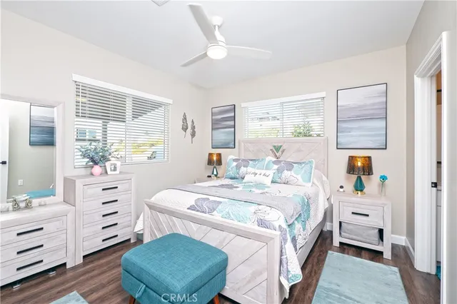 a spacious bedroom with a bed and a dresser