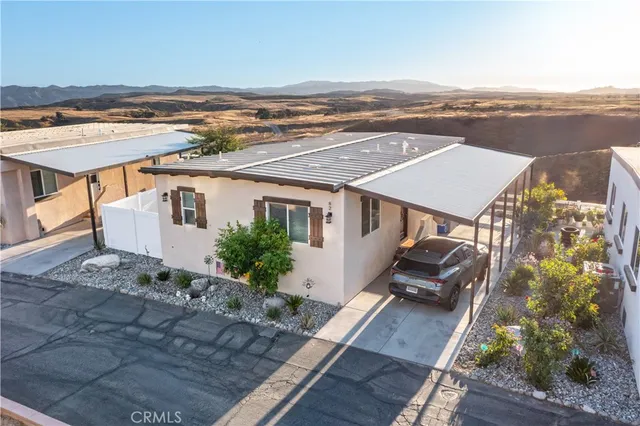 a view of a patio with table and chairs and potted plants
