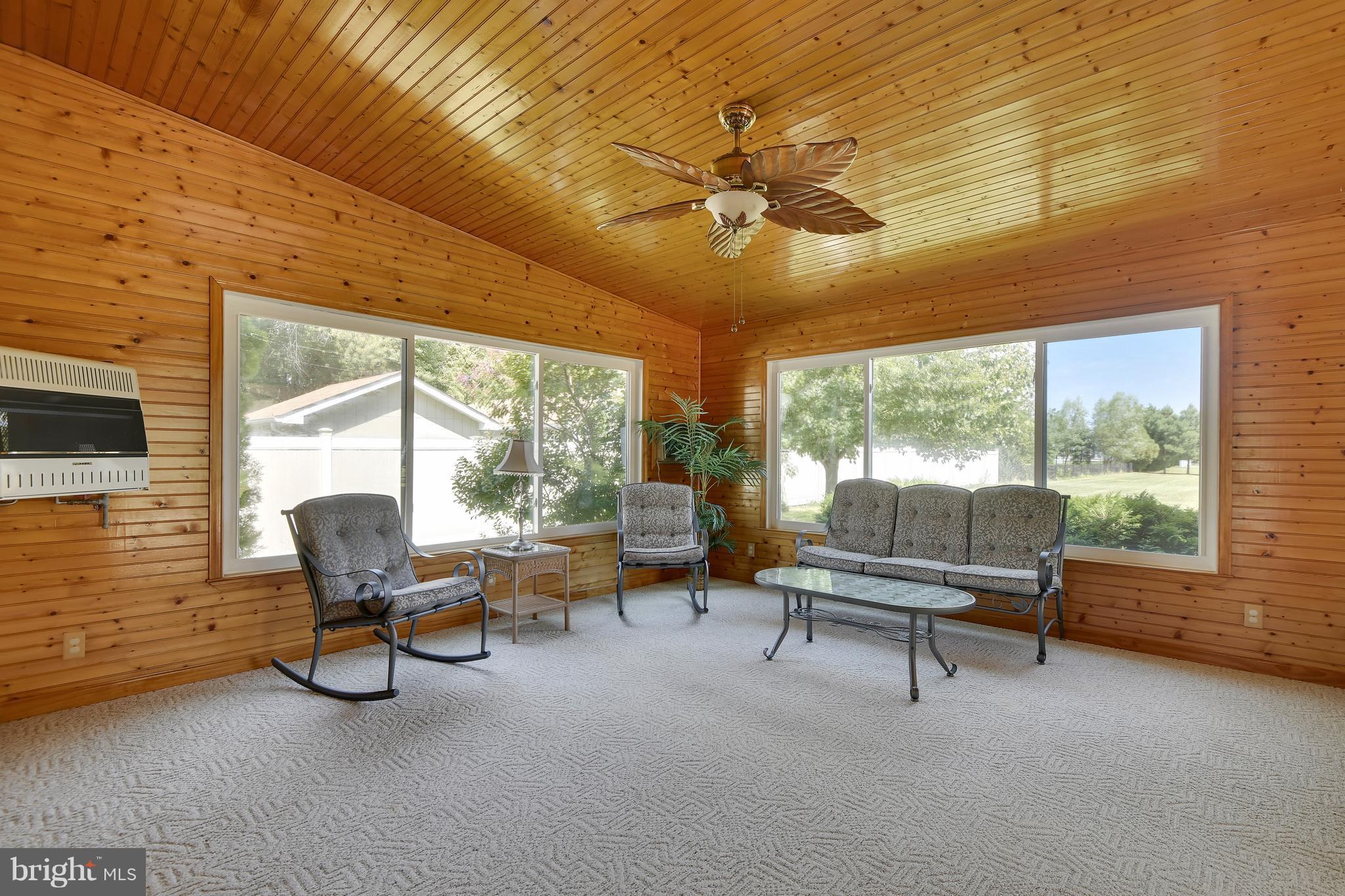 122 Cedar Road Chester, MD 21619 - Photo 11 of 28 a living room with furniture and large windows
