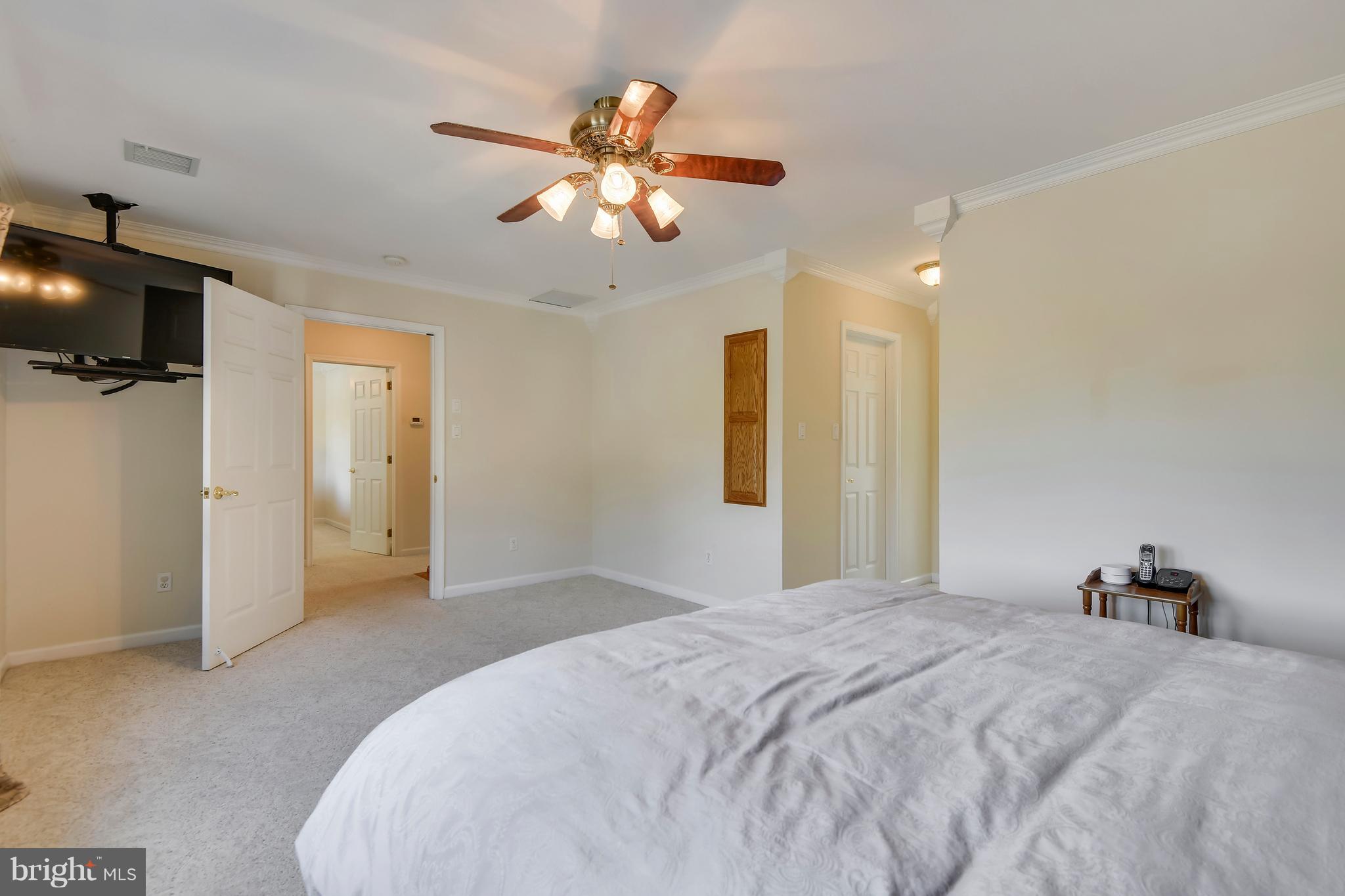 122 Cedar Road Chester, MD 21619 - Photo 15 of 28 a bedroom with a bed and a chandelier