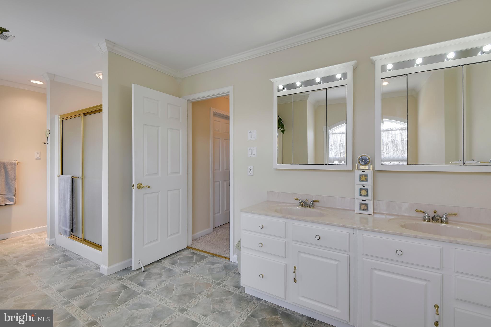 122 Cedar Road Chester, MD 21619 - Photo 16 of 28 a bathroom with double sink and a mirror
