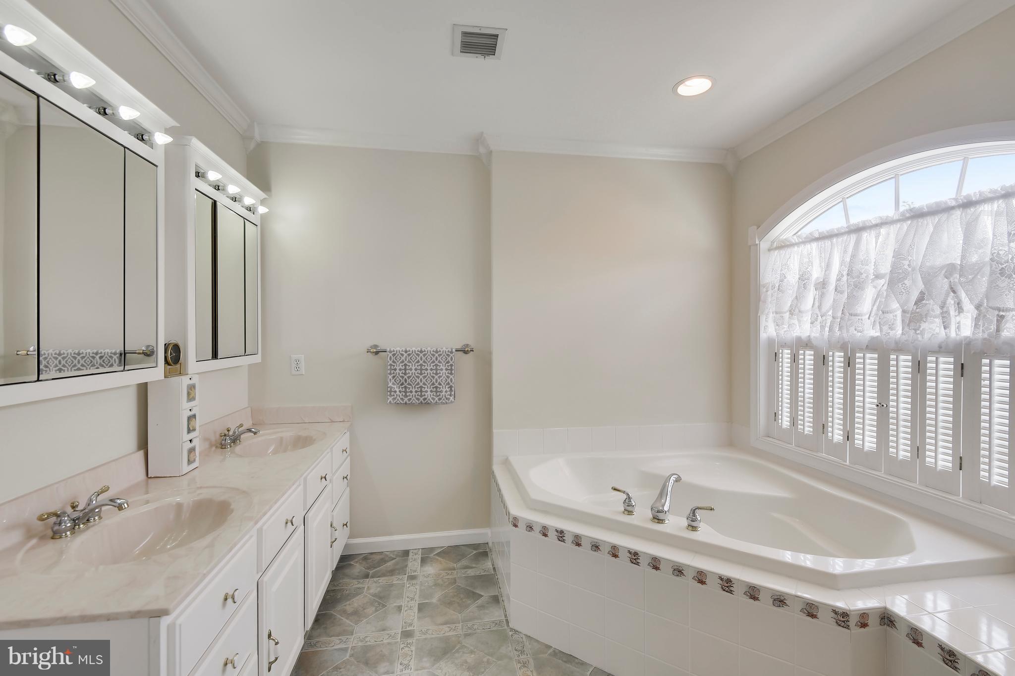 122 Cedar Road Chester, MD 21619 - Photo 17 of 28 a bathroom with a tub sink and mirror