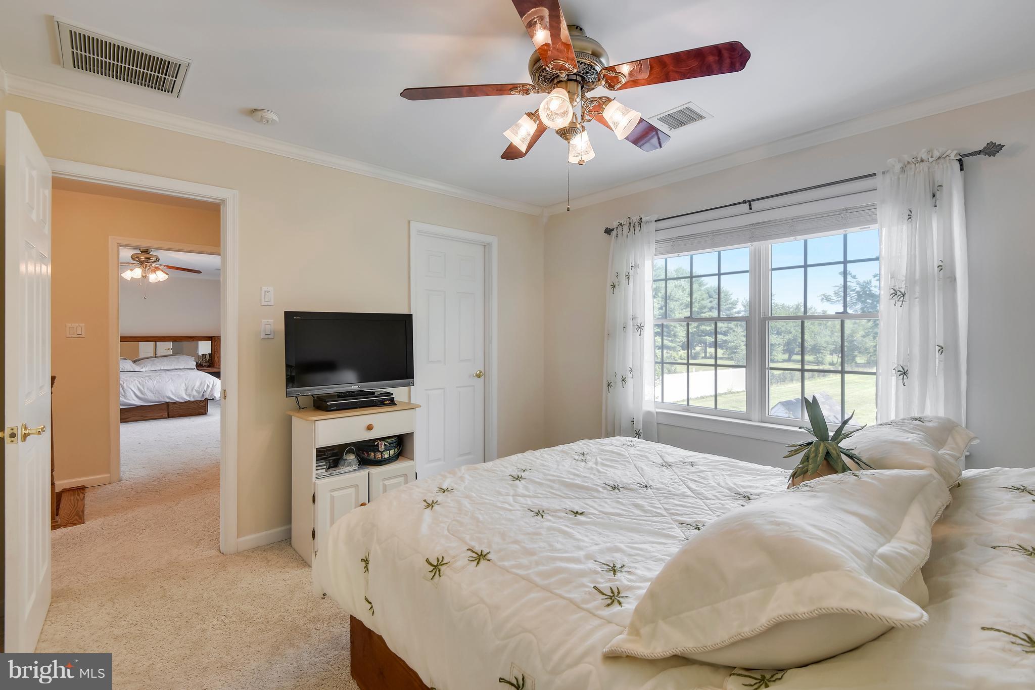 122 Cedar Road Chester, MD 21619 - Photo 18 of 28 a bedroom with a bed and a flat screen tv