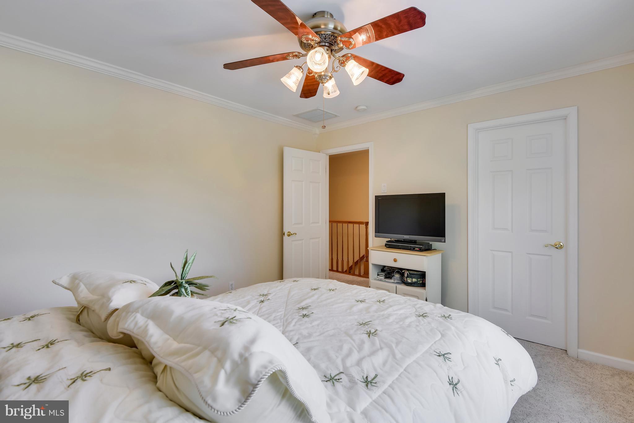 122 Cedar Road Chester, MD 21619 - Photo 19 of 28 a bedroom with a bed and a flat screen tv