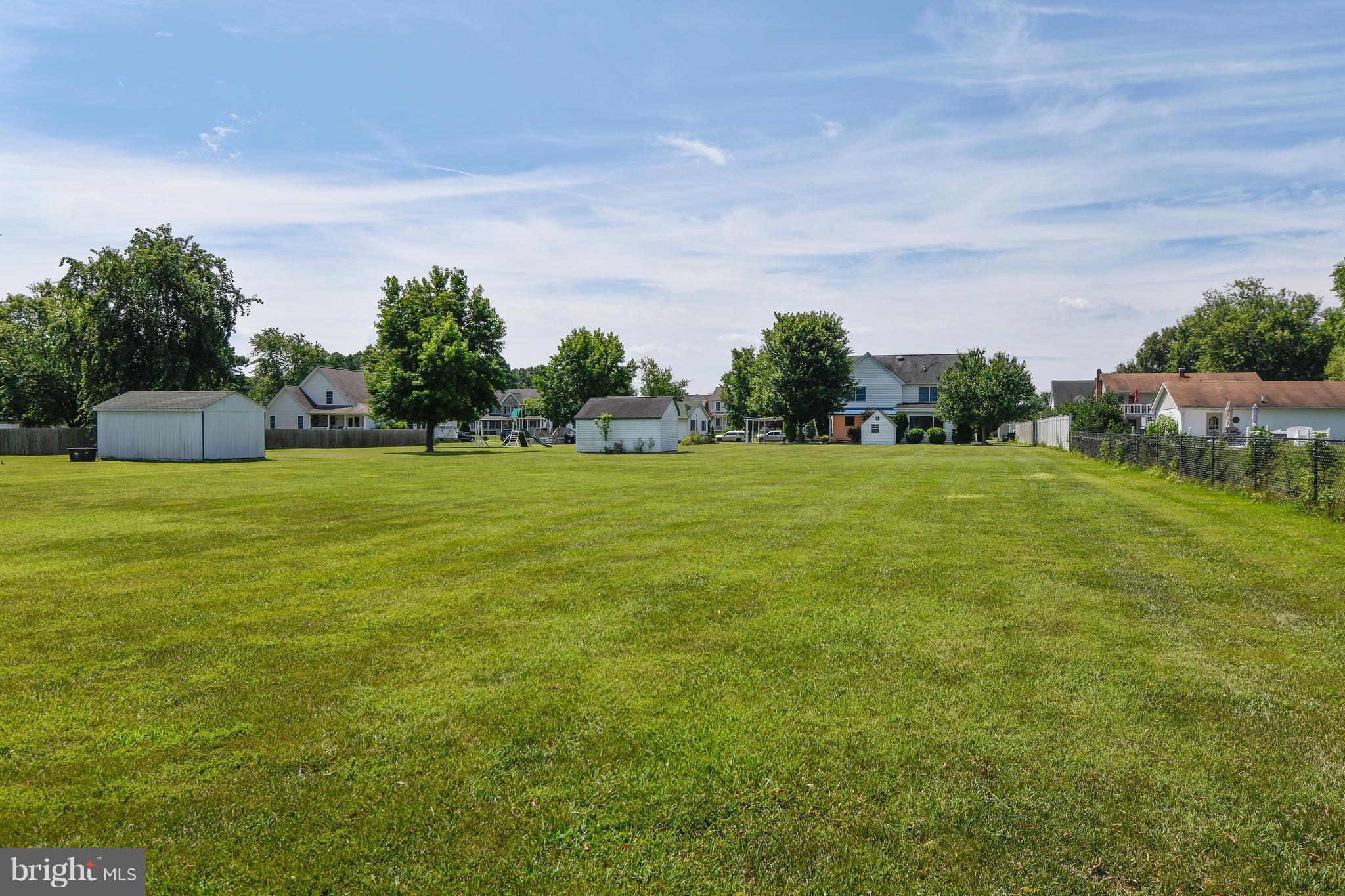 122 Cedar Road Chester, MD 21619 - Photo 27 of 28 a view of a grassy field with trees in the background