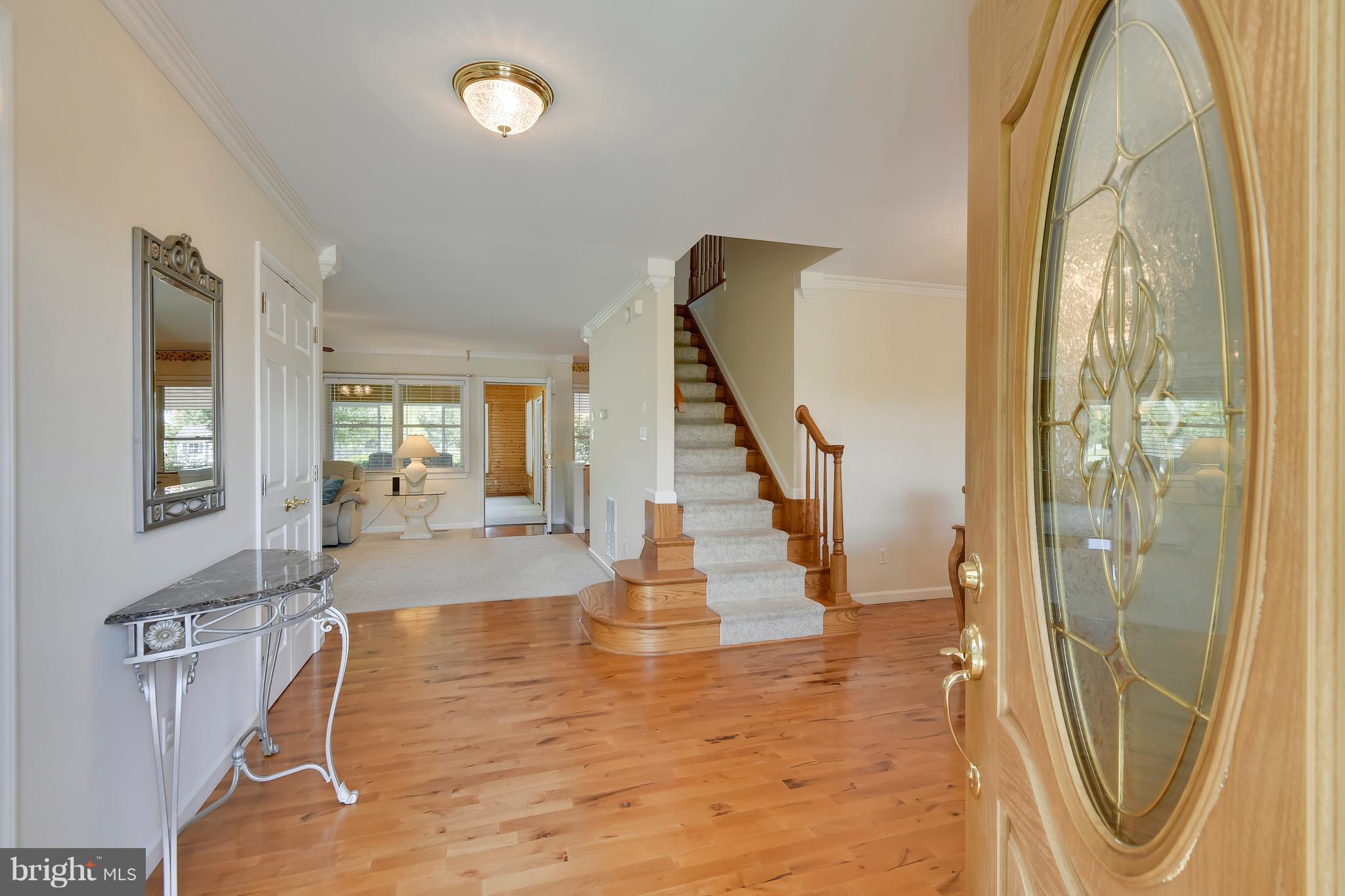 122 Cedar Road Chester, MD 21619 - Photo 5 of 28 a view of a hallway with wooden floor and staircase