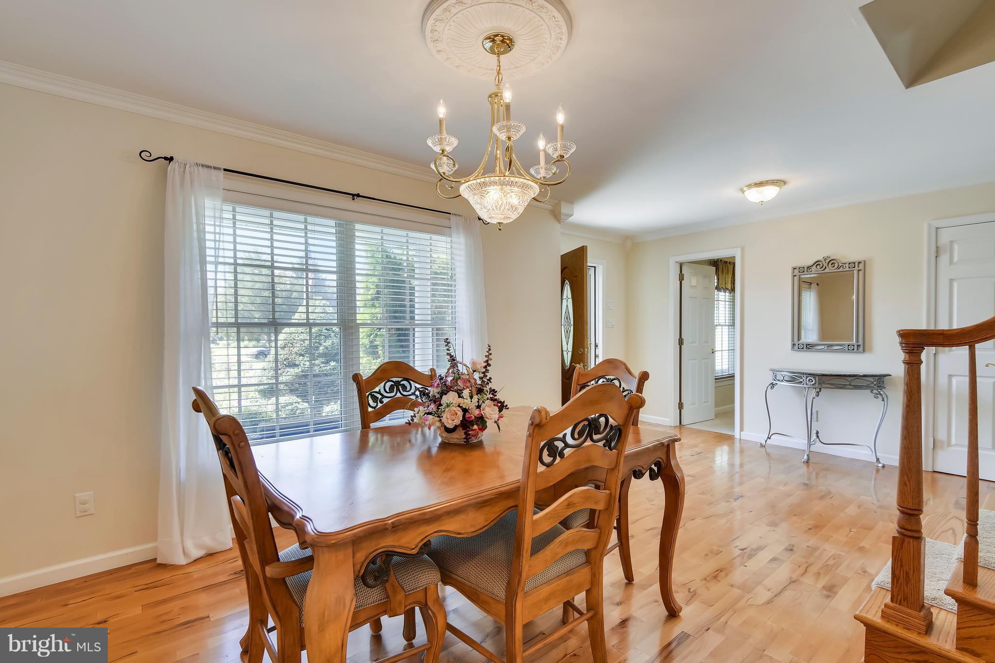 122 Cedar Road Chester, MD 21619 - Photo 6 of 28 a view of a dining room with furniture and chandelier