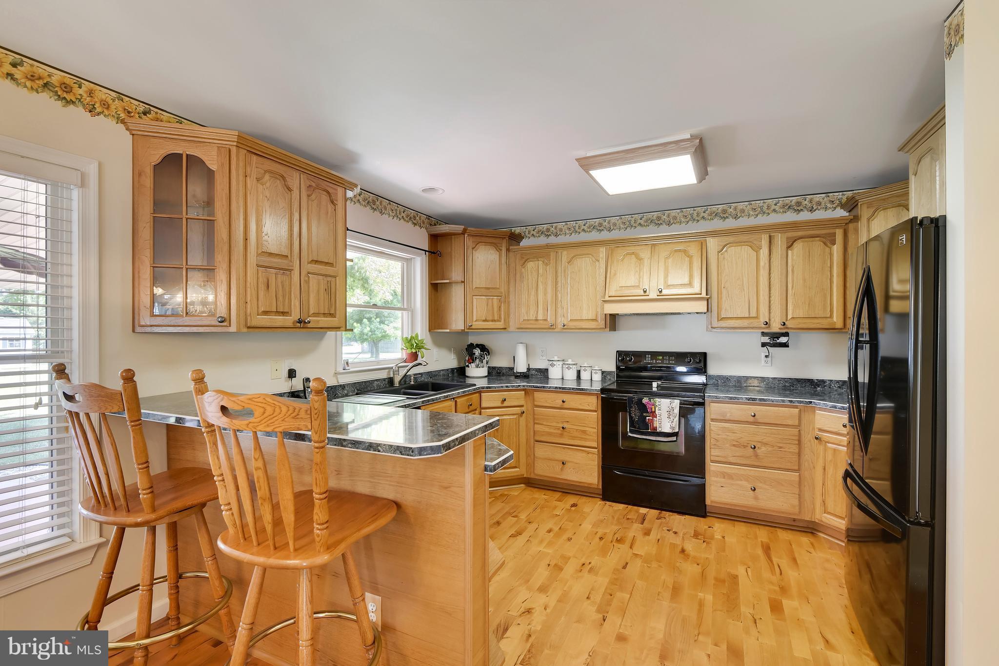122 Cedar Road Chester, MD 21619 - Photo 10 of 28 a kitchen with stainless steel appliances granite countertop a stove top oven a sink dishwasher and cabinets with wooden floor