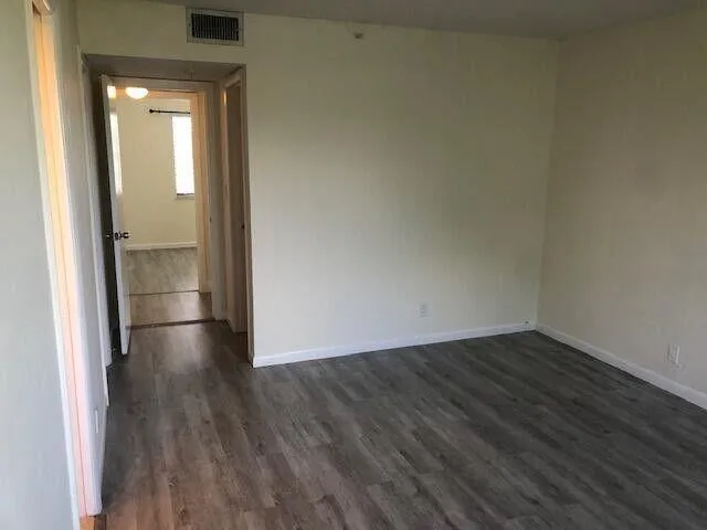 a view of wooden floor in an empty room