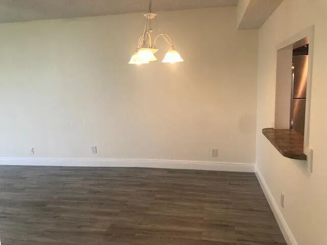 a view of a room with wooden floor and staircase