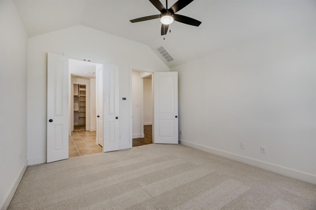 4314 Haley Way Oak Point, TX 75068 - Photo 14 of 28 Spacious interior room with vaulted ceiling and a dark-toned ceiling fan