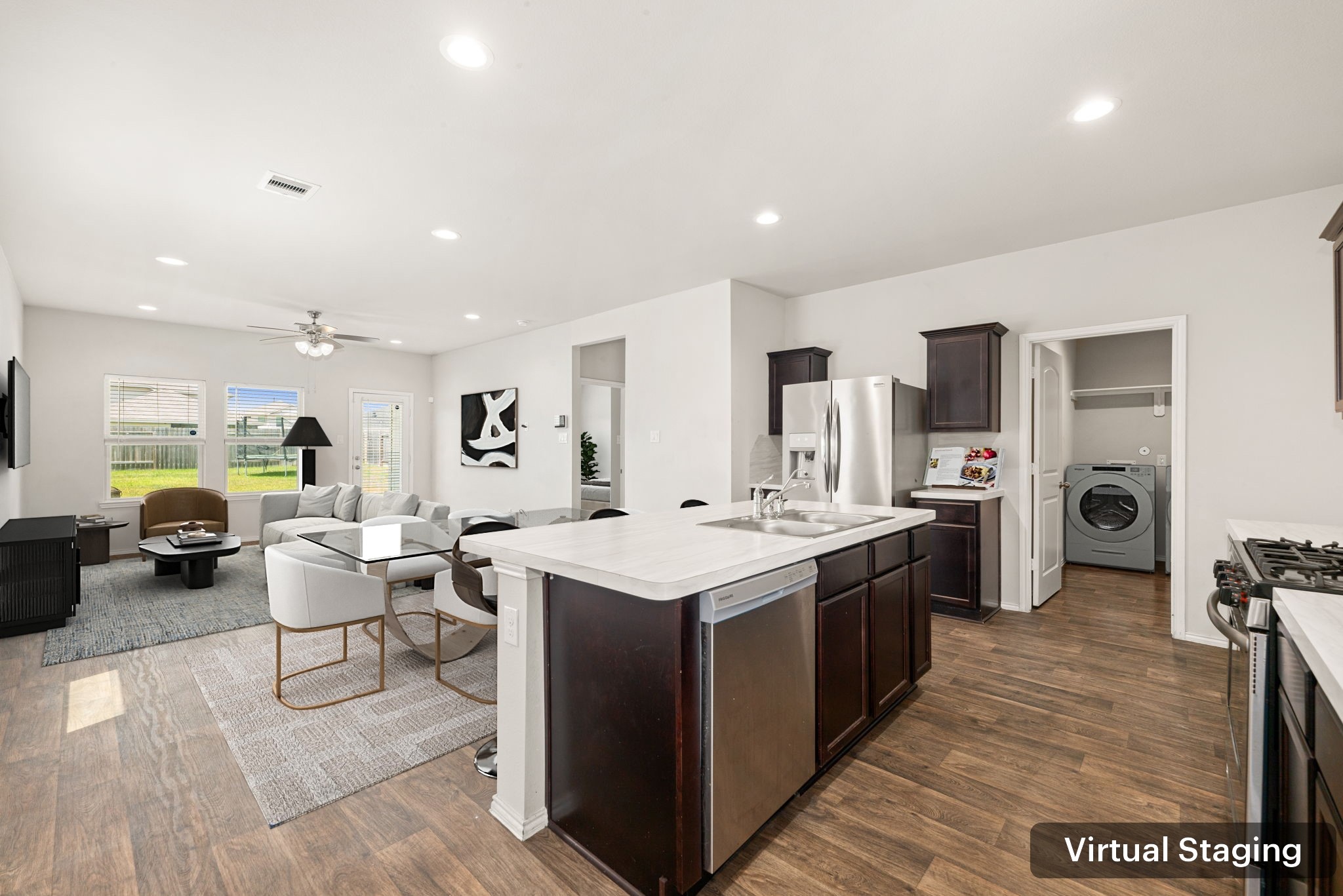 23119 Rivercane Shadow Trail Spring, TX 77373 - Photo 4 of 32 a large kitchen with stainless steel appliances a stove a sink dishwasher and a refrigerator with wooden floor