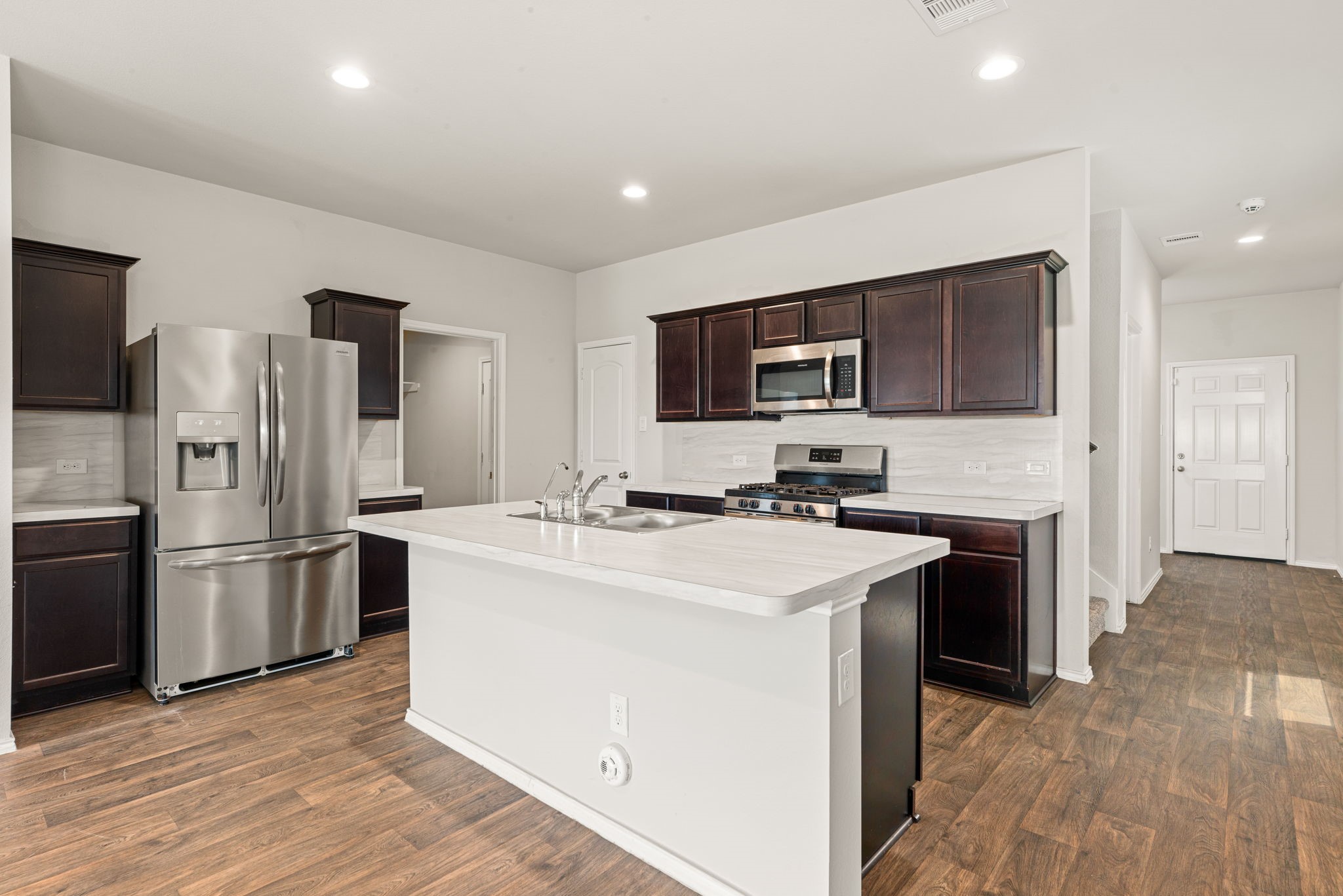23119 Rivercane Shadow Trail Spring, TX 77373 - Photo 5 of 32 a kitchen with appliances a sink cabinets and a counter top space