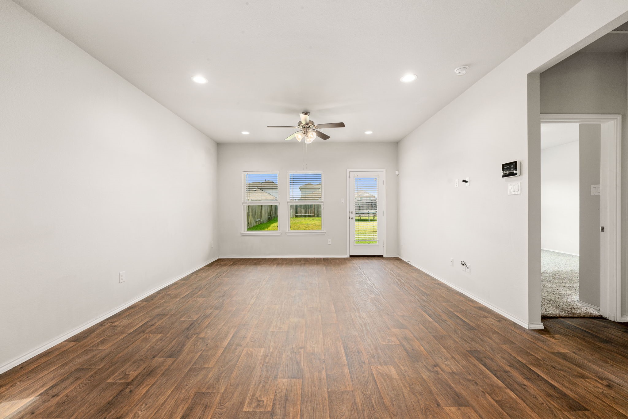 23119 Rivercane Shadow Trail Spring, TX 77373 - Photo 8 of 32 wooden floor in an empty room with a window