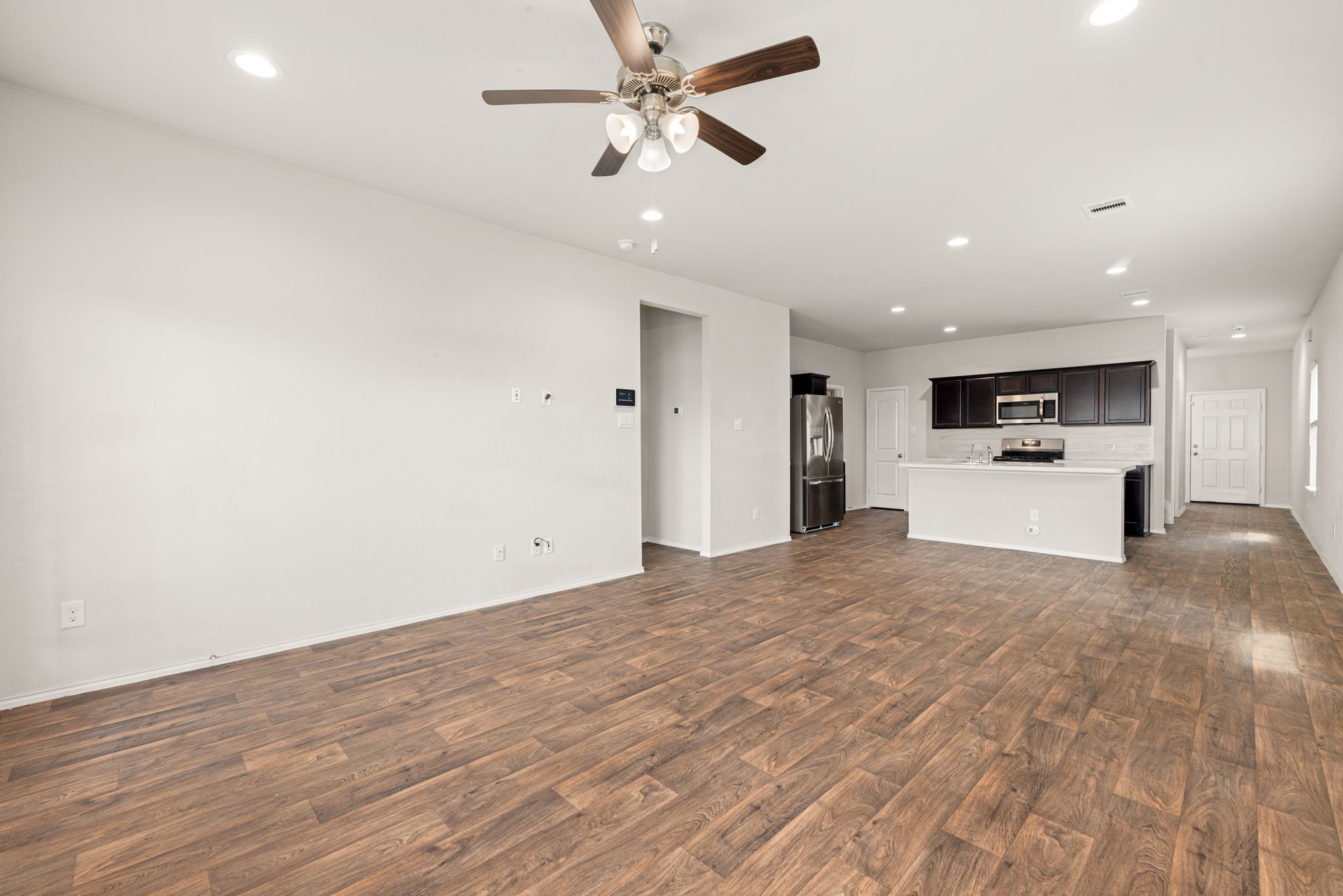 23119 Rivercane Shadow Trail Spring, TX 77373 - Photo 9 of 32 a view of a kitchen with a sink and a refrigerator
