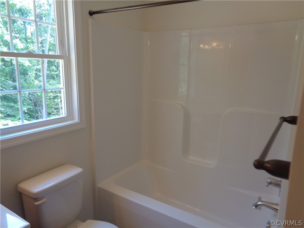 7112 Oakfork Loop New Kent, VA 23124 - Photo 14 of 21 a bathroom with a bathtub and a window