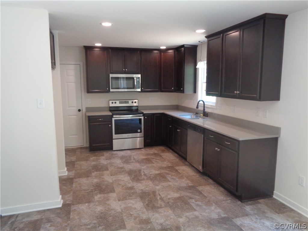 7112 Oakfork Loop New Kent, VA 23124 - Photo 5 of 21 a kitchen with stainless steel appliances granite countertop a sink and a stove