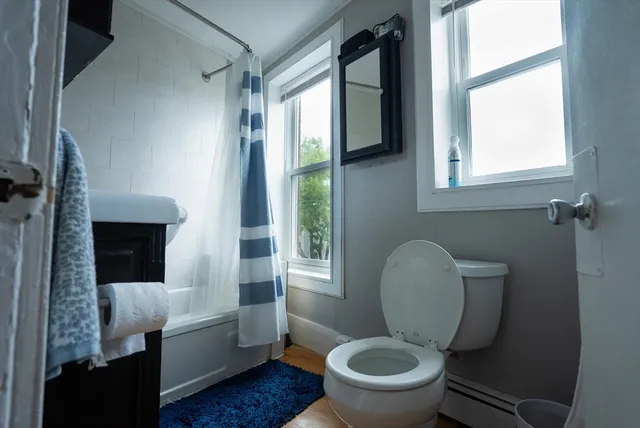 a white toilet sitting next to a bathroom sink