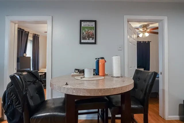 a view of a dining room with furniture and wooden floor