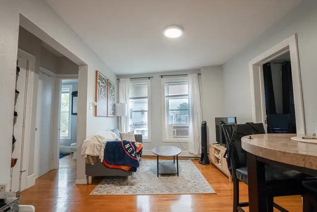 a living room with furniture rug and window