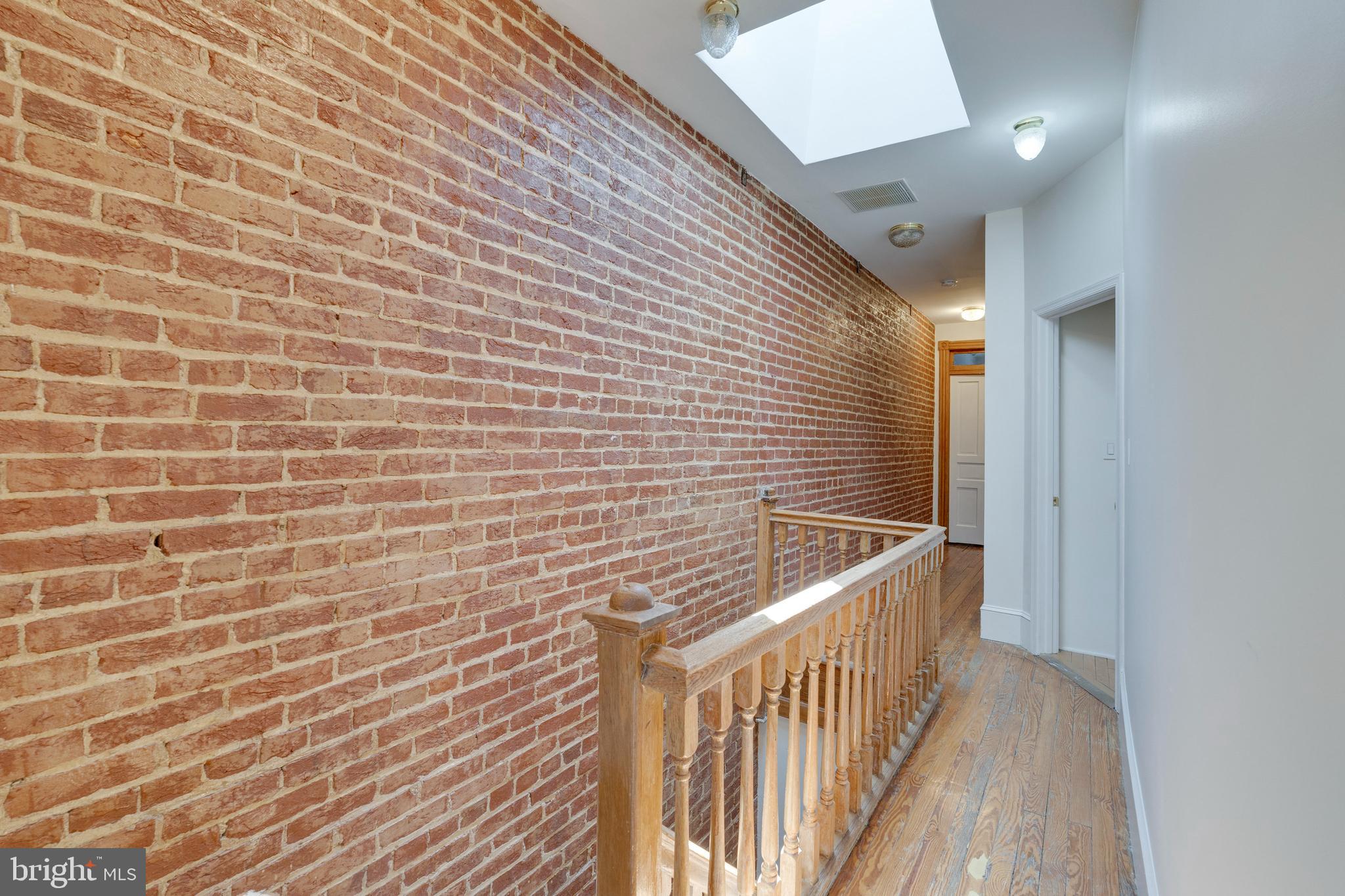 33 R Street Northeast, Unit A Washington, DC 20002 - Photo 18 of 33 Exposed brick wall on top level.