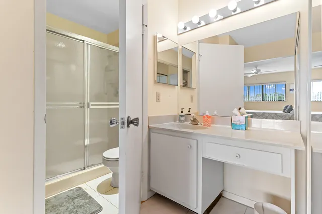 a bathroom with a shower sink and mirror