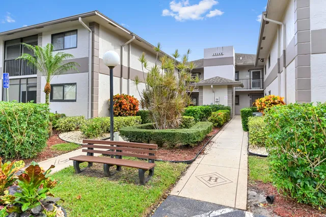 a view of a patio with table and chairs and potted plants