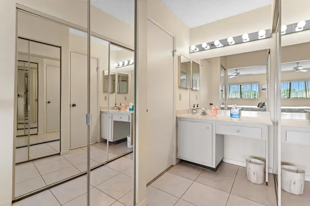 a bathroom with a double vanity sink mirror and toilet