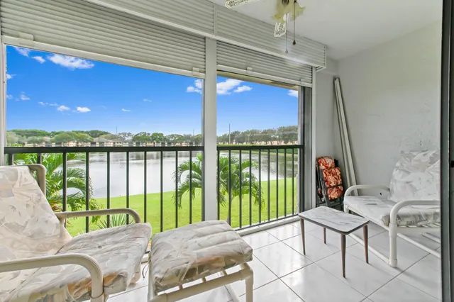 a bed sitting in a balcony next to a yard