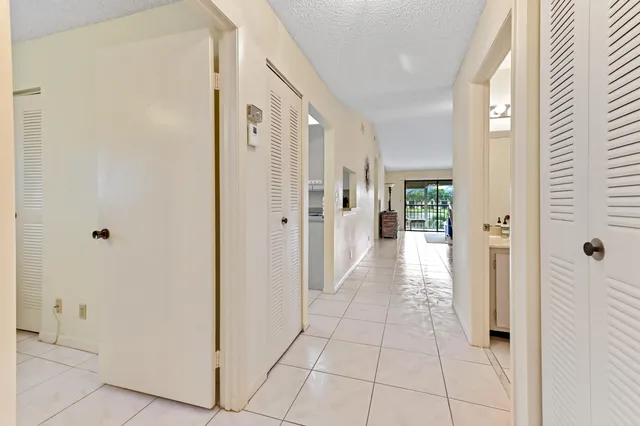 a view of a hallway with a wooden cabinets