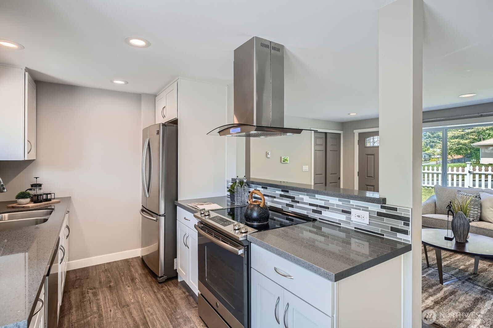 3501 Northeast 10th Street Renton, WA 98056 - Photo 12 of 28 a kitchen with stainless steel appliances granite countertop a sink stove and refrigerator