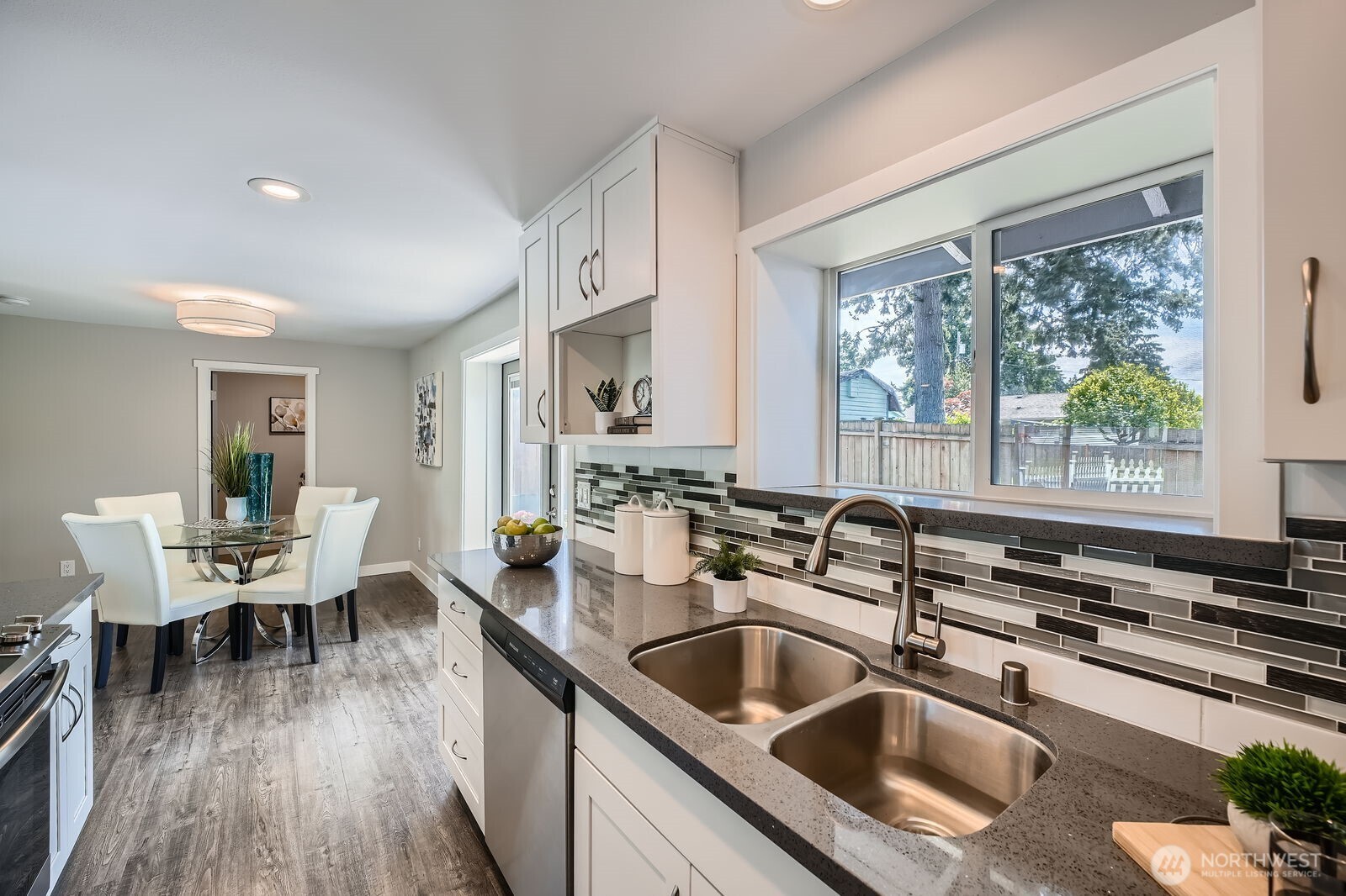 3501 Northeast 10th Street Renton, WA 98056 - Photo 13 of 28 a kitchen with a sink stove and wooden floor
