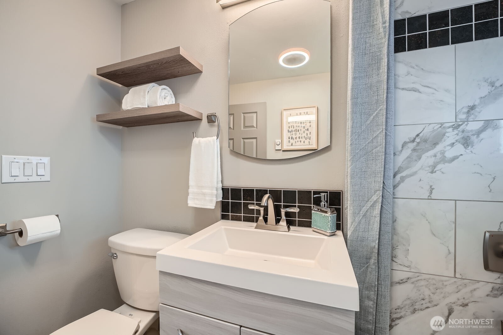 3501 Northeast 10th Street Renton, WA 98056 - Photo 19 of 28 a bathroom with a toilet a sink and mirror