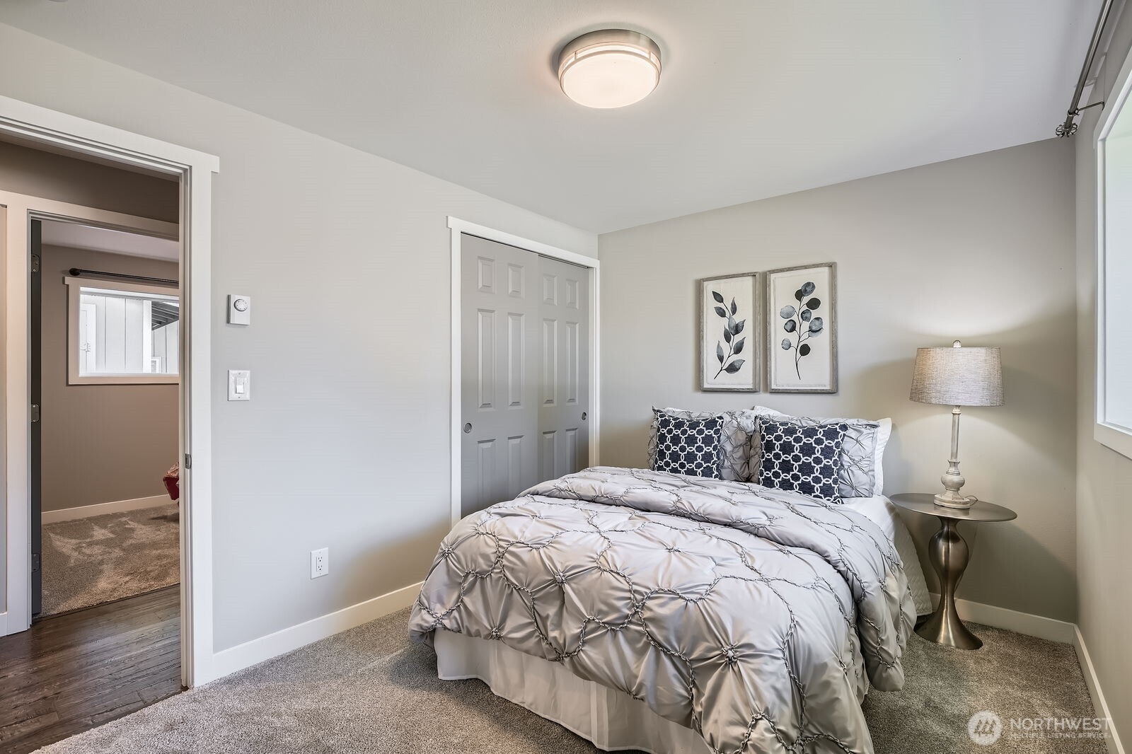 3501 Northeast 10th Street Renton, WA 98056 - Photo 21 of 28 a bedroom with a bed and a lamp
